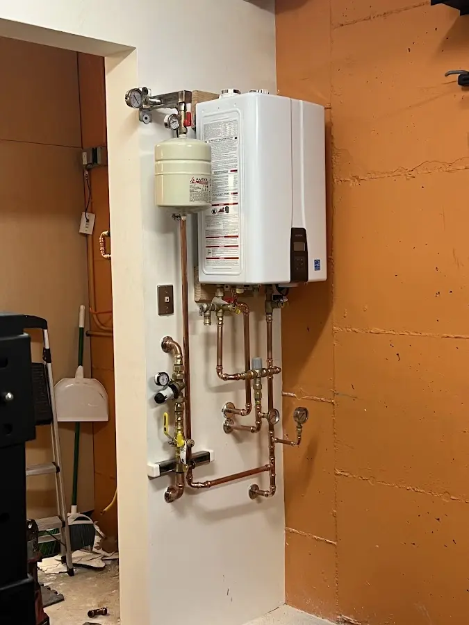Plumbing technician inspecting water heater connections in Beaufort
